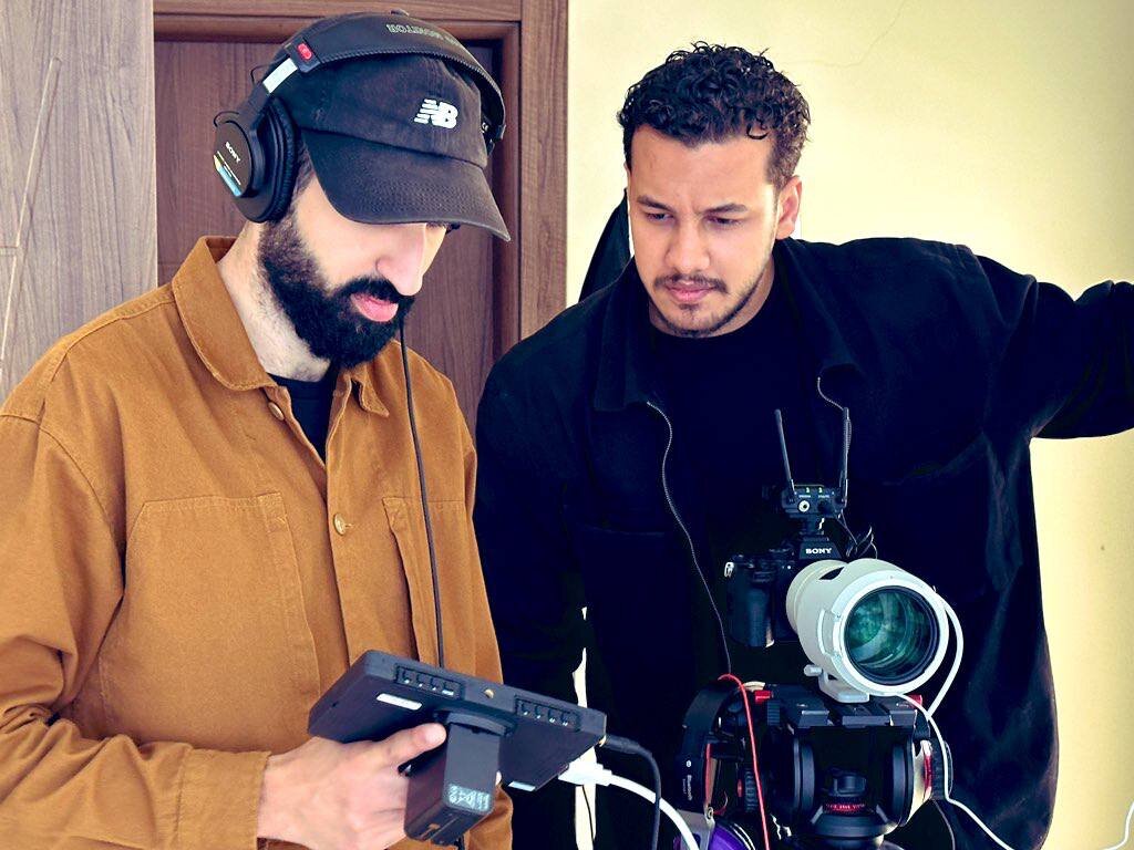 Mohammed checking the frame on the monitor with his DOP
